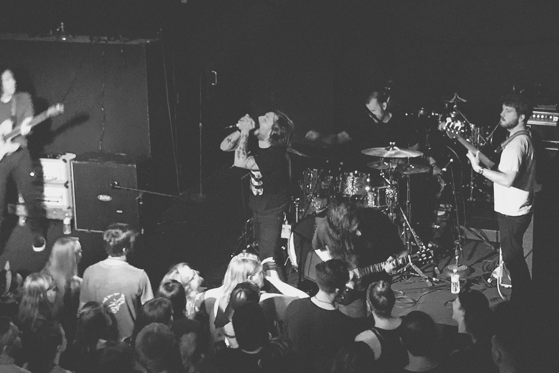 Black and white view of a band performing on stage